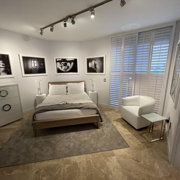 White satin laminate cylinder pedestals as bedside tables