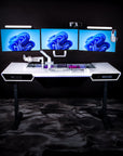 The Overkill Battle Station – Pedestal Source. Custom white laminate display table with three gaming monitors, a keyboard, and lights.